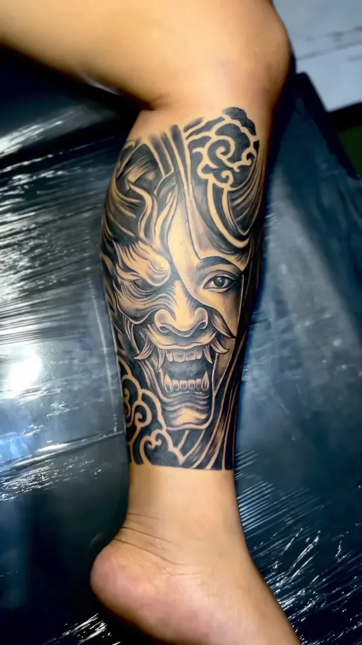 Fierce traditional Balinese mask, black and grey realism on a calf