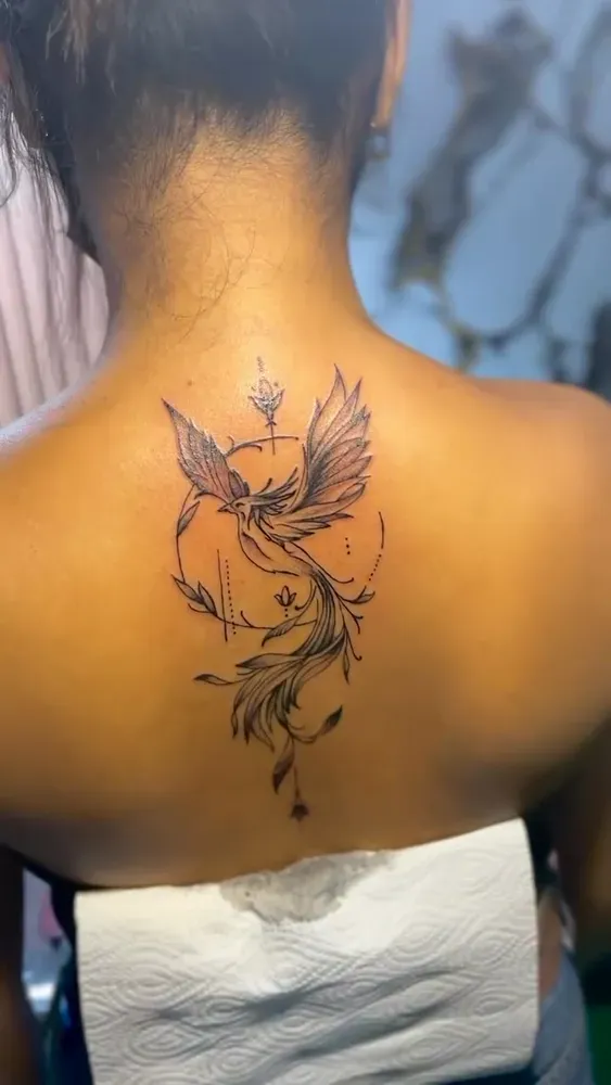 Fine line phoenix with geometric accents, fresh on the back of the neck