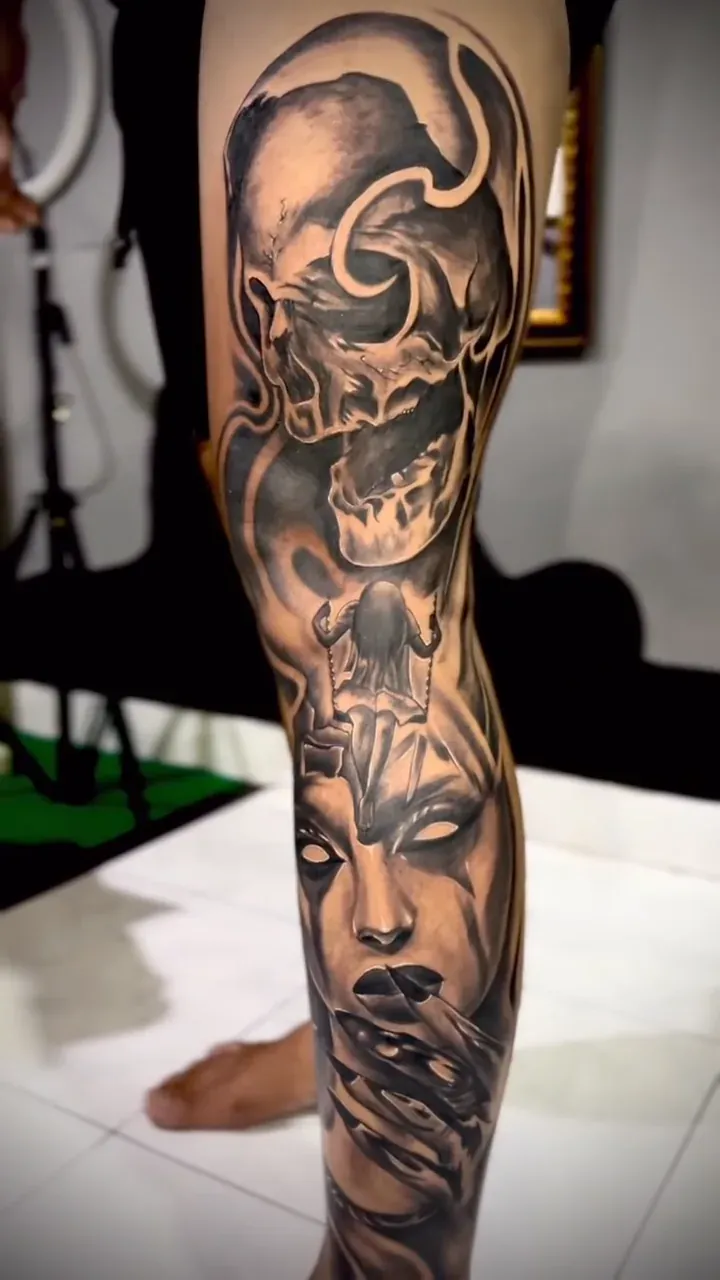 Realistic skull with a shaded figure beneath it, black and grey